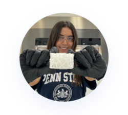 Close-up of a woman in goggles and gloves doing experiment holding EOS 3D printed polymer part